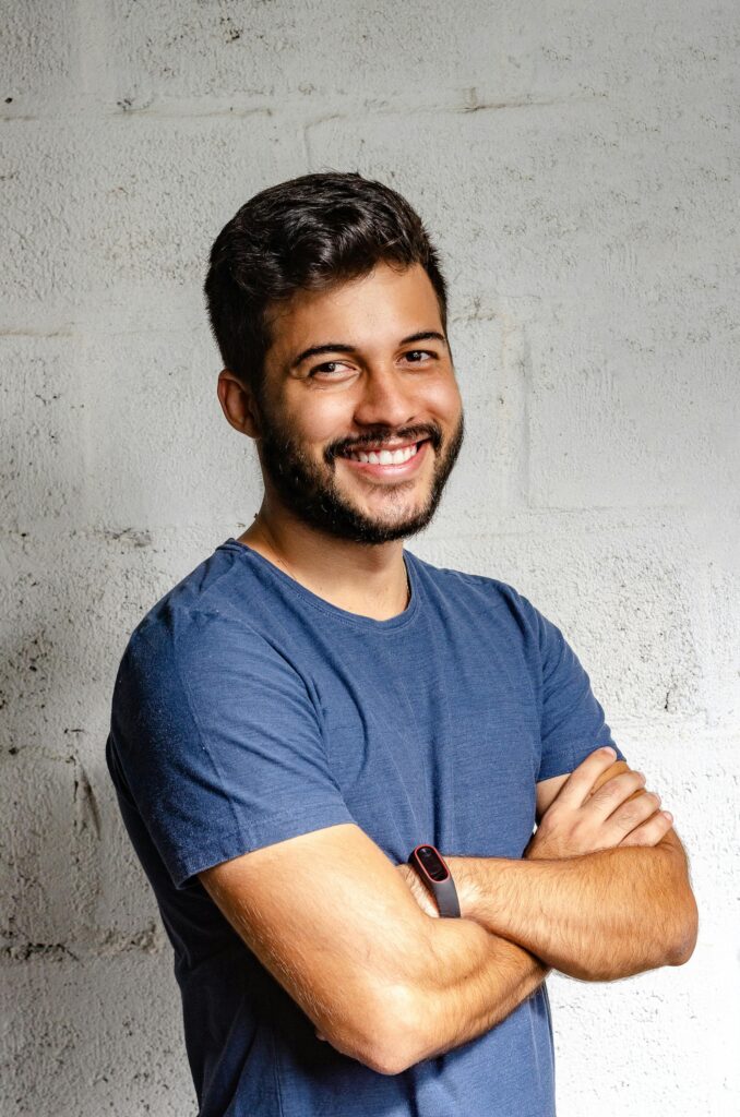 pexels photo 2379004 2379004 Portrait of a happy man with arms crossed, exuding confidence and friendliness.